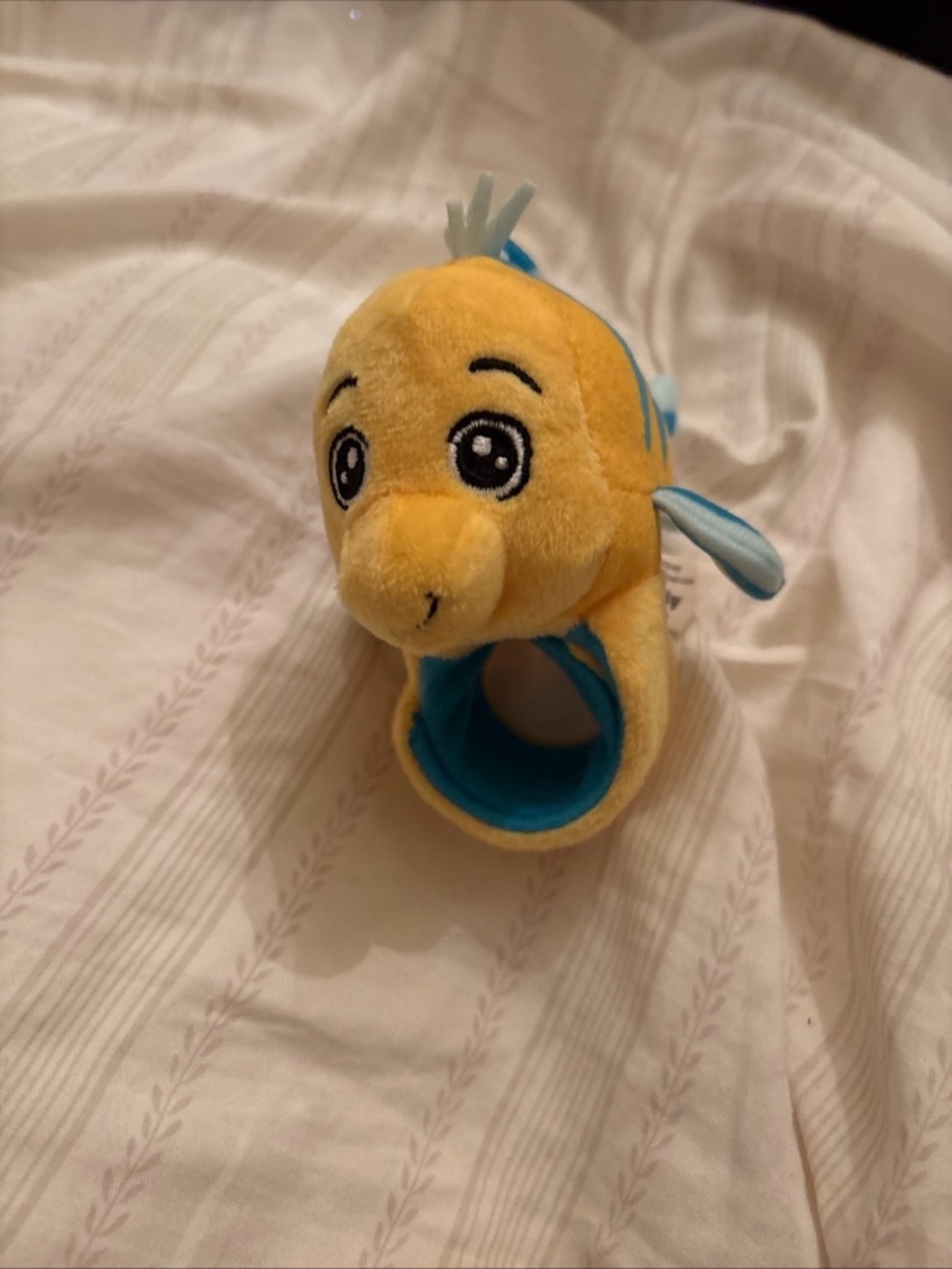 Cutie Cuff Series 3 Flounder plush toy, as a wearable slap bracelet